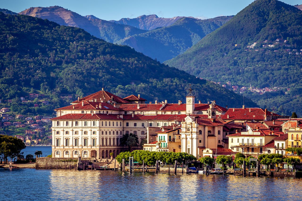 luxury Stresa Lake Maggiore, Borromean Islands private tour, Villa Palazzo Aminta, Lake Maggiore boat excursion, Italian lakes luxury hotel, Luxury lake view room at Villa Palazzo Aminta Hotel Stresa with balcony, Private mahogany boat approaching Isola Bella Borromean Islands, Ten-terraced Italian gardens at Isola Bella Palace Lake Maggiore, White peacock strolling through Isola Bella botanical gardens, Venetian terrazzo floors and marble columns at Villa Aminta lobby, Panoramic view of Stresa and Lake Maggiore from alpine perspective, Baroque palace interior at Isola Bella with priceless art collection, Fresh lake fish dish at Isola dei Pescatori restaurant, Colorful peacocks in botanical gardens at Isola Madre, Private boat cruising Lake Maggiore with alpine mountain backdrop.