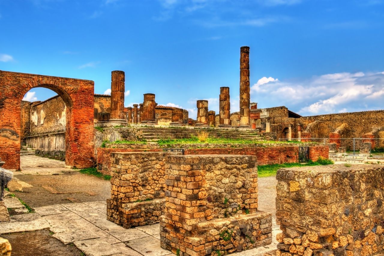 luxury Sorrento tour, private Capri boat tour, Pompeii VR experience, Amalfi Coast private driver, Sorrento luxury hotel, Luxury sea view room with balcony at Hotel Corallo Sorrento overlooking Bay of Naples, Private Cranchi 32 boat touring Capri's Faraglioni rock formations, Pompeii VR experience showing ancient city reconstruction through headset, Panoramic view of Positano's vertical village from Amalfi Coast road, Pizza making class with chef in Sorrento with wood-fired oven, Infinity jacuzzi at Hotel Corallo with Mediterranean sea views, Blue Grotto Capri with sunlight creating electric blue water, Ravello's Villa Cimbrone Terrace of Infinity with coastal views, Ancient Roman ruins at Pompeii with Mount Vesuvius in background, Sorrento lemon groves with traditional pergolas and fresh lemons.